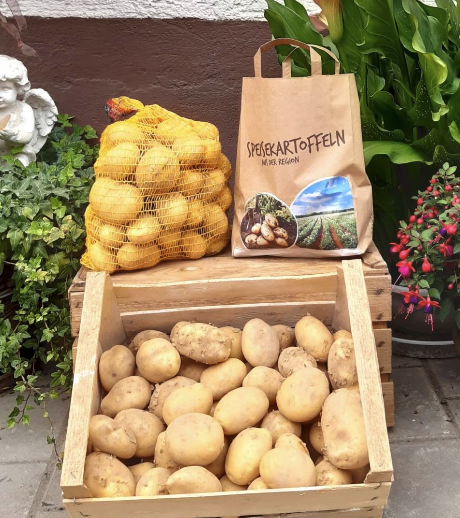 Speisekartoffeln in der Holzkiste und im Netz zum Ab-Hof-Verkauf